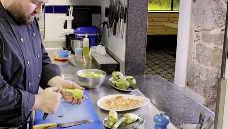 caucasian cook pealing and cutting aartichokes in restaurant