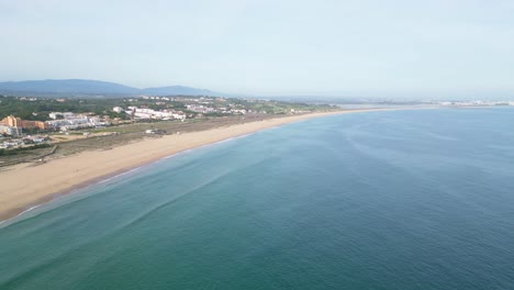 The praia de são roque beach, capturing the expansive golden dunes and coastline, aerial view