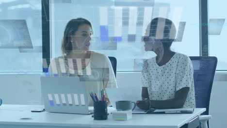 Animation-of-graphs-and-globes-over-diverse-female-coworkers-discussing-reports-on-laptop-in-office