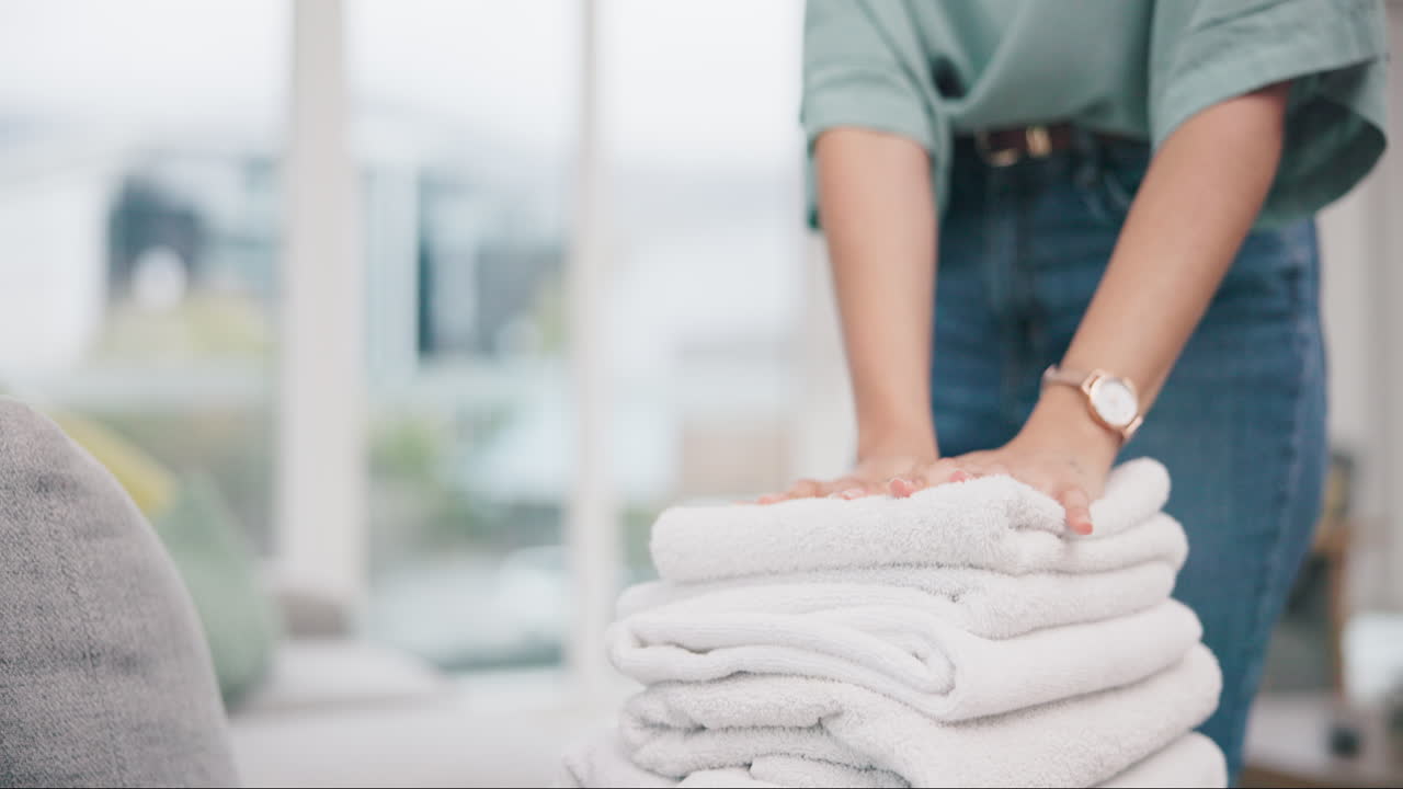 Laundry, hands and woman packing towel
