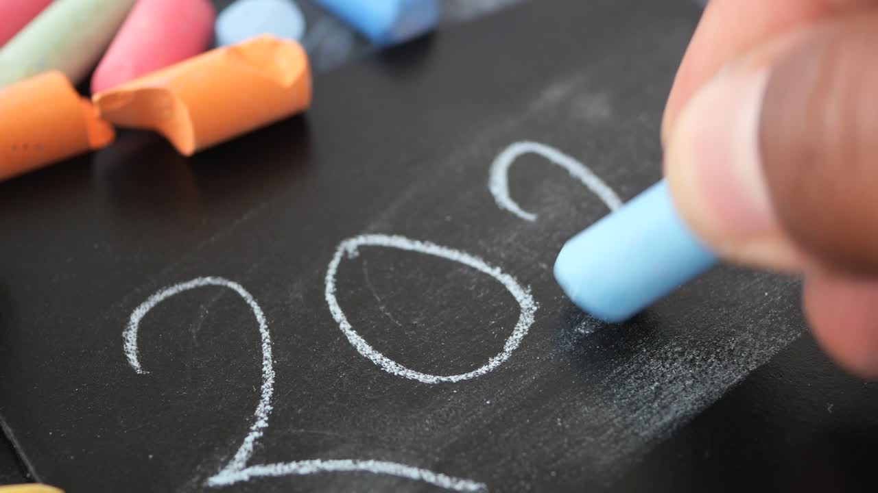 Writing 2025 on a chalkboard with colorful chalk