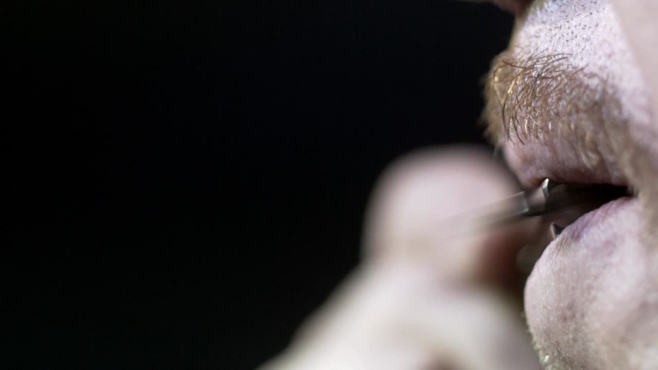 Man Holding Object in Mouth