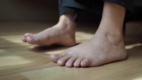 bare feet on wooden floor