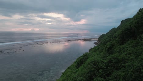 Beautiful-reflection-in-the-calm-turquoise-Indian-ocean-at-Green-bowl-beach-at-Bali-in-Indonesia-during-sunset