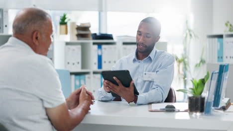 doctor discussing with elderly patient