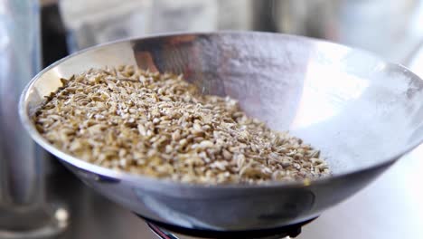 Close-up-shot-of-barley-being-poured-onto-a-scale-for-weighing