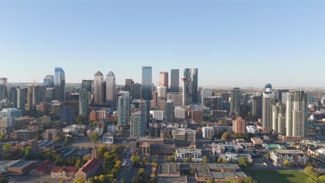 the downtown core of calgary alberta is seen from an aerial drone perspective showing the calgary tower, bow building and other major features