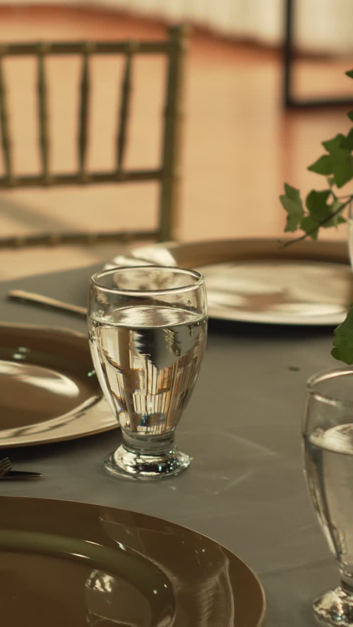 Hall with tables decorated for wedding reception with fresh flowers. Banquet table. Vertical.