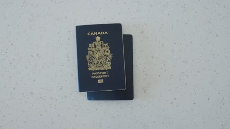 canada passport falls on top of usa passport