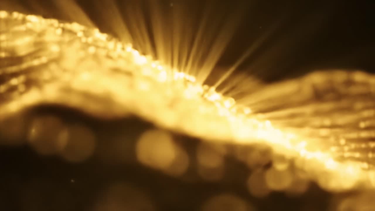 Intricate golden light patterns dance and flow across the surface, creating an enchanting visual experience. This captivating display highlights the elegance of light in an artistic manner.