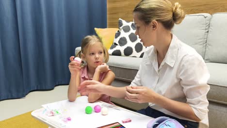 mother and daughter doing arts and crafts at home