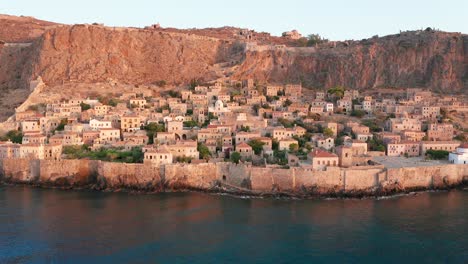 still shot of monemvasia city in a cliff during sunrise