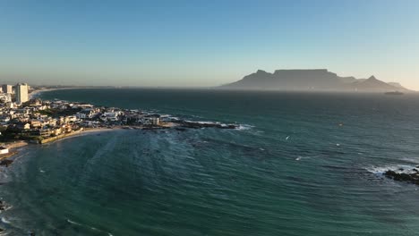 Aerial-view-of-flat-Table-mountain-seen-from-Cape-Towns-Big-Bay-in-sunset-glow