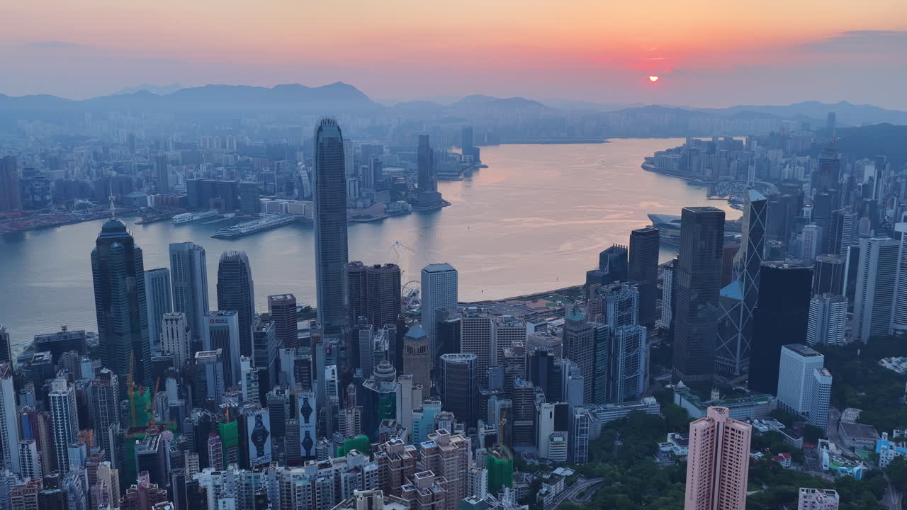 Cinematic Aerial view of Hong Kong skyline featuring IFC and ICC towers, symbolizing global finance, modern architecture, and a vibrant hub for travel and business