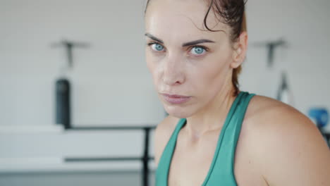 woman at the gym, sweating and determined