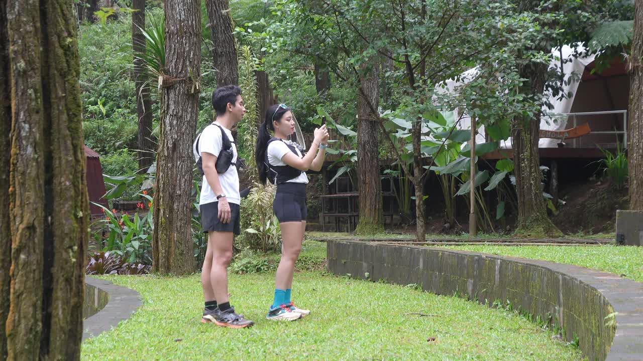 Indonesian young adults using smartphone during trail run in forest