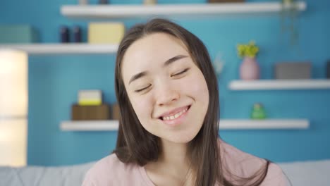 Close-up-portrait-of-cute-and-sympathetic-young-Asian-woman.