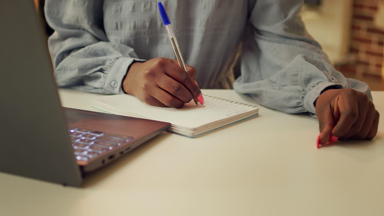 Blogger writing story ideas on notebook