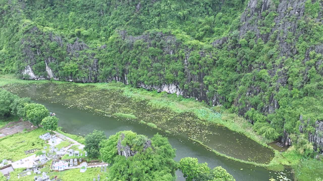 Peaceful bay view with boats cruising around lush islets in Ha Long Bay, Vietnam