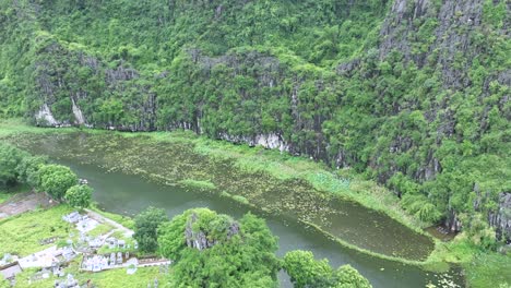 peaceful bay view with boats cruising around lush islets in ha long bay, vietnam