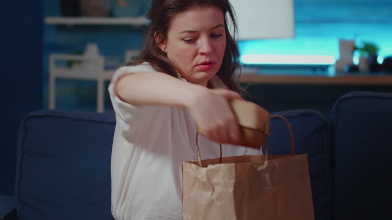 Caucasian person removing face mask after getting takeout meal