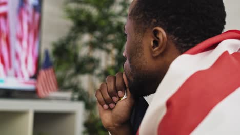 tracking video of black man watching tv anxiously