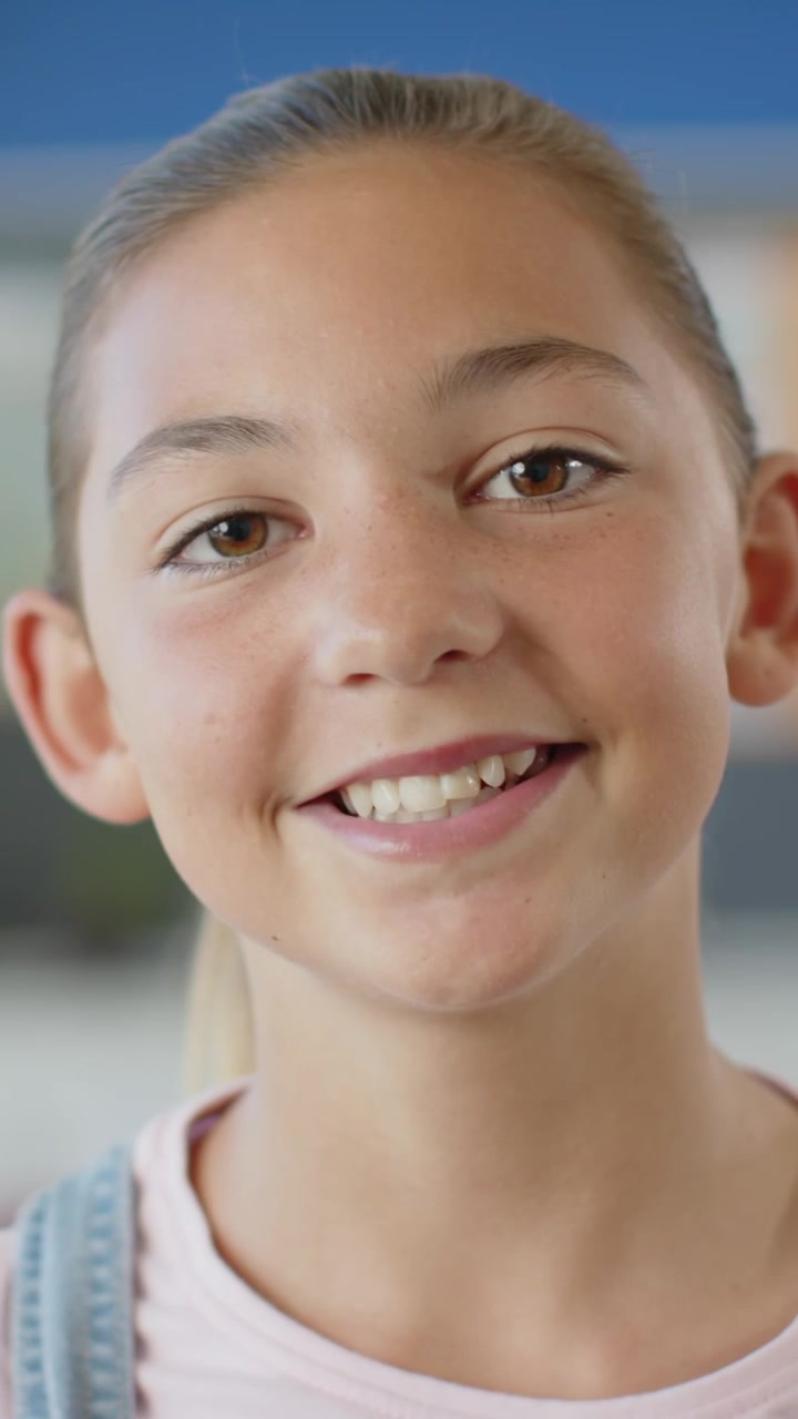 Child is smiling and speaking in flat design medium-close shot, wearing pink shirt and denim straps