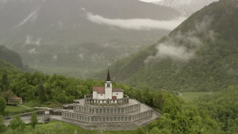 mountain chapel in a misty valley