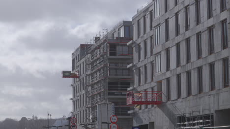 scaffoldings and external platforms on the exterior of a building under construction in gdynia, poland