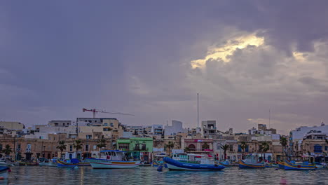 A-Time-Lapse-Shot-Of-A-City-By-The-Waterfront-With-Colourful-Boats-In-The-Sea