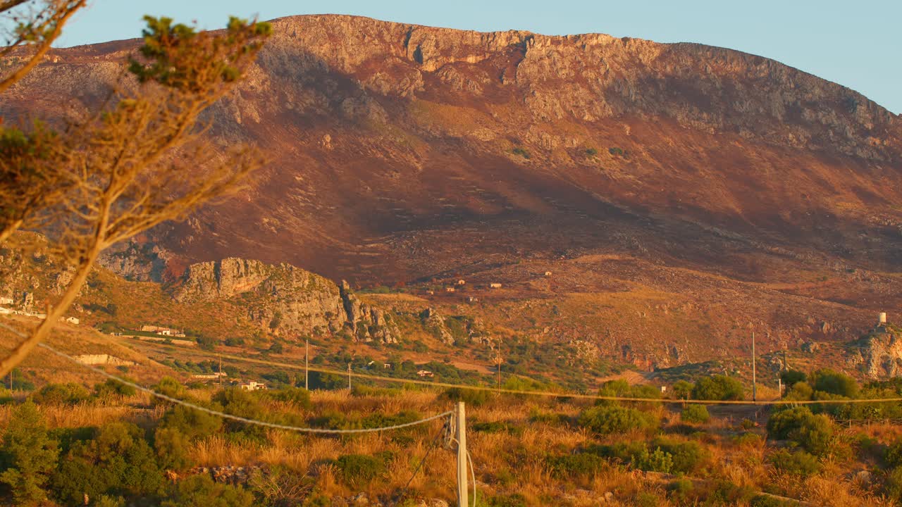 Golden sun on rustic Sicilian landscape near Guidaloca beach, Italy