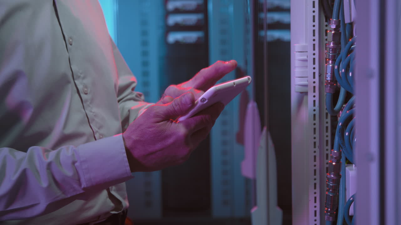 Male Data Center Technician Working in Server Room