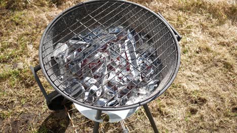 round charcoal grill in the backyard.