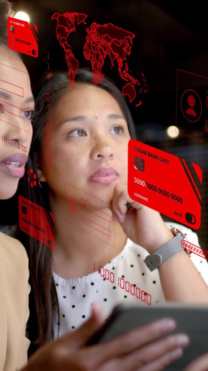 Vertical video: Woman holding tablet pointing revealing red AR UI with finance data as peer leans