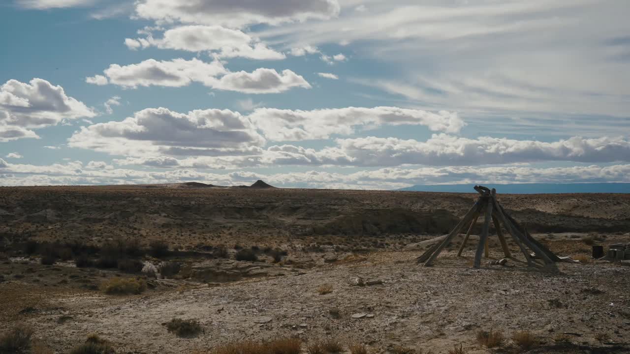 Time-lapse of dramatic clouds sweeping over a barren desert badlands landscape. Perfect for sci-fi, westerns, post-apocalyptic scenes, or cinematic travel visuals