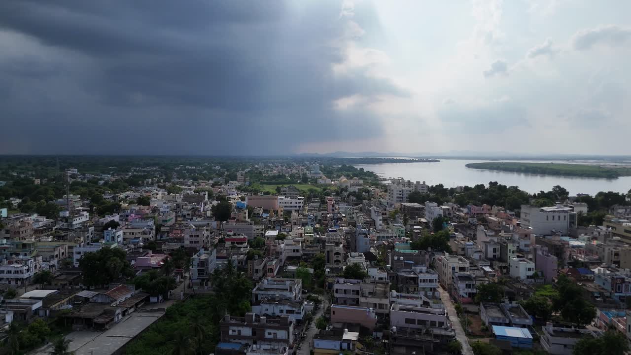 Drone footage showcasing the vibrant architecture of Vijayawada with a lush green hill completing the scenic view.