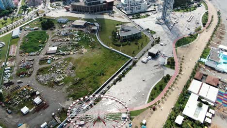 coastal ferris wheel in batumi city, near black sea coastline, aerial view