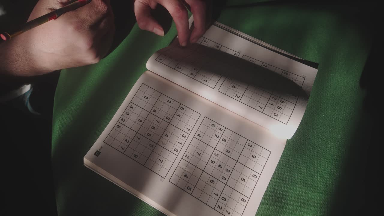 Person concentrating in study room with brain teaser numbers puzzle TOP DOWN