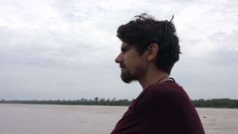 Close-up-shot-of-a-white-male-Caucasian-traveler's-face-on-a-boat-on-Amazon-river-in-rainforest,-Brazil