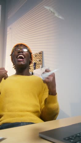 man celebrating with money