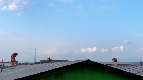 industrial chimneys on the roof of factory building which produces smoke from combustion activity