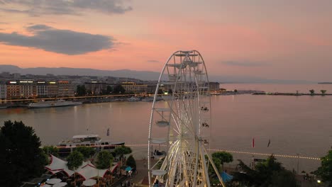 sunset sky night illumination geneva city center traffic ferris wheel aerial panorama 4k switzerland