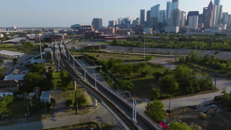 aerial view rotating over a metro train, revealing downtown houston, sunny morning