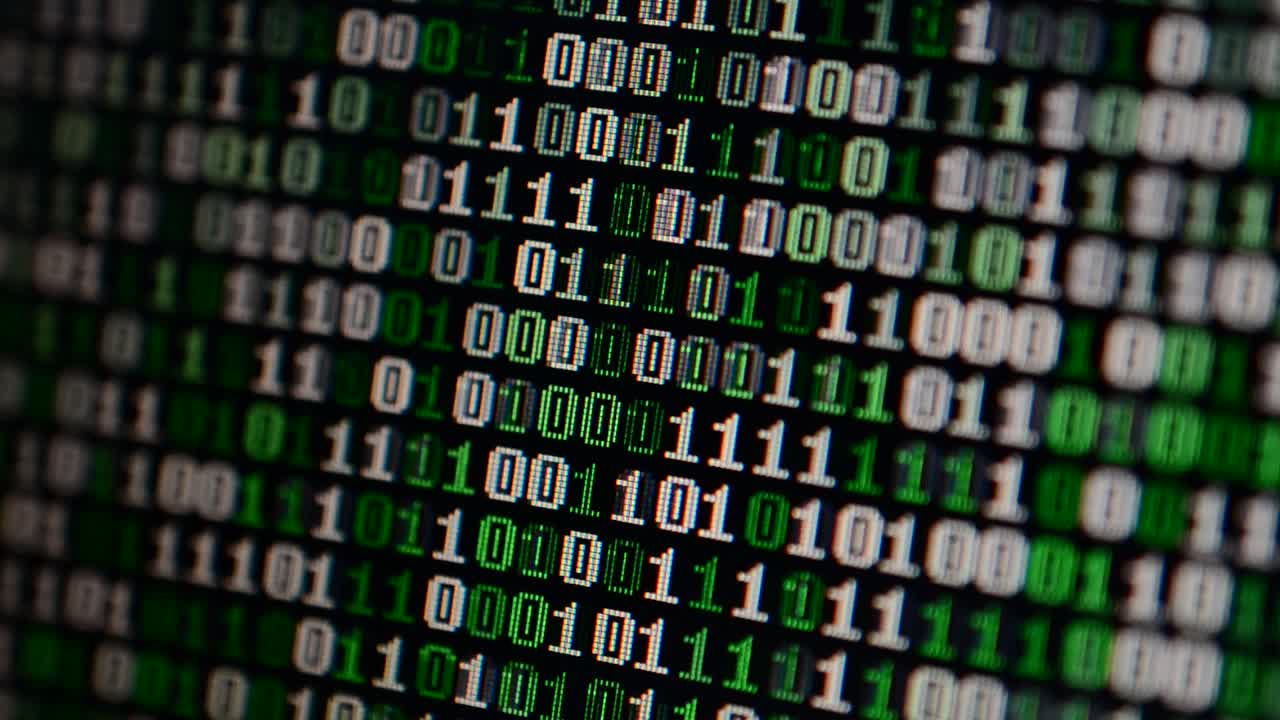 Binary code on the monitor screen. Shooting of a binary code, background