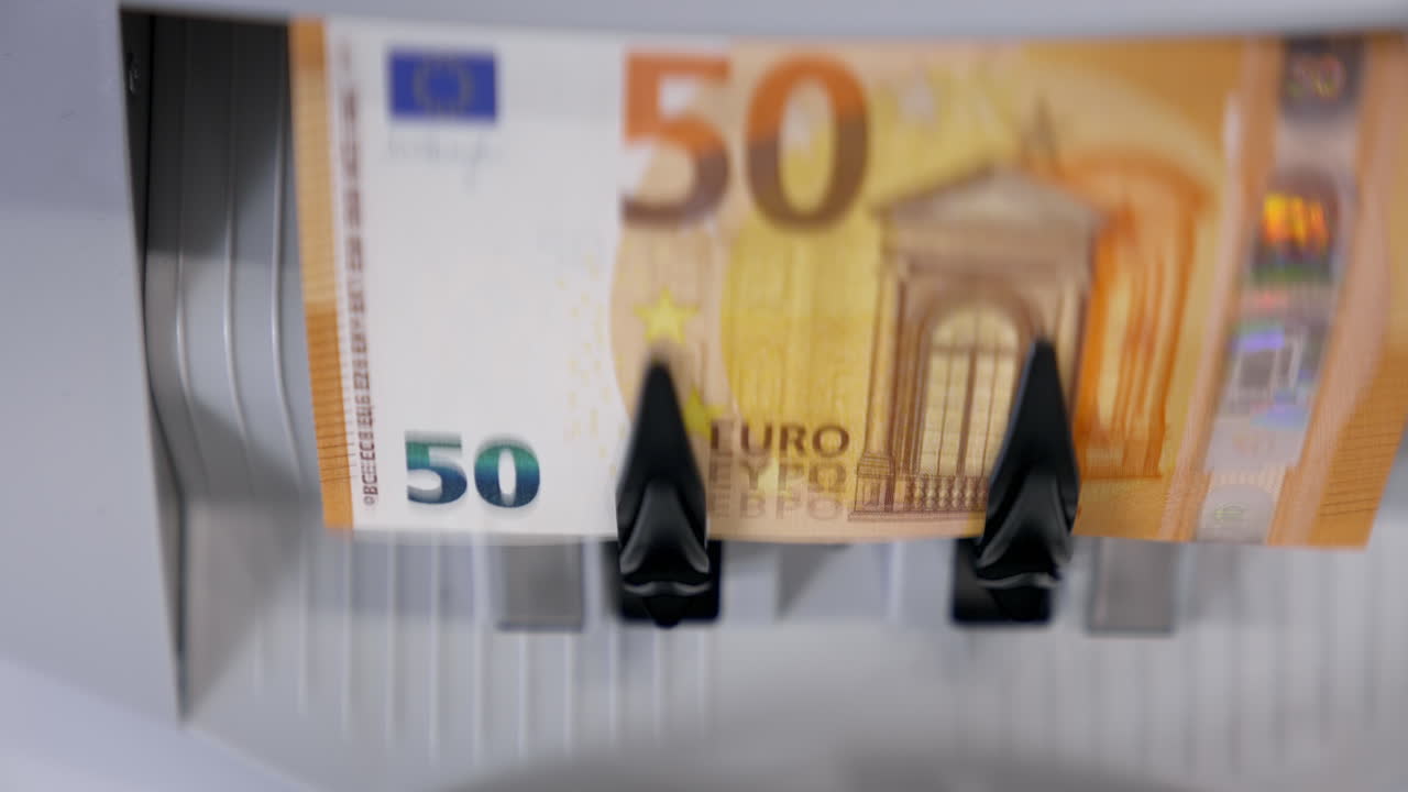 Work of counter machine. Currency counting equipment. Electronic banknote counter counting euro bills. Finance business concept. Close-up.