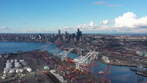 aerial view flying over the port of seattle towards the city skyline