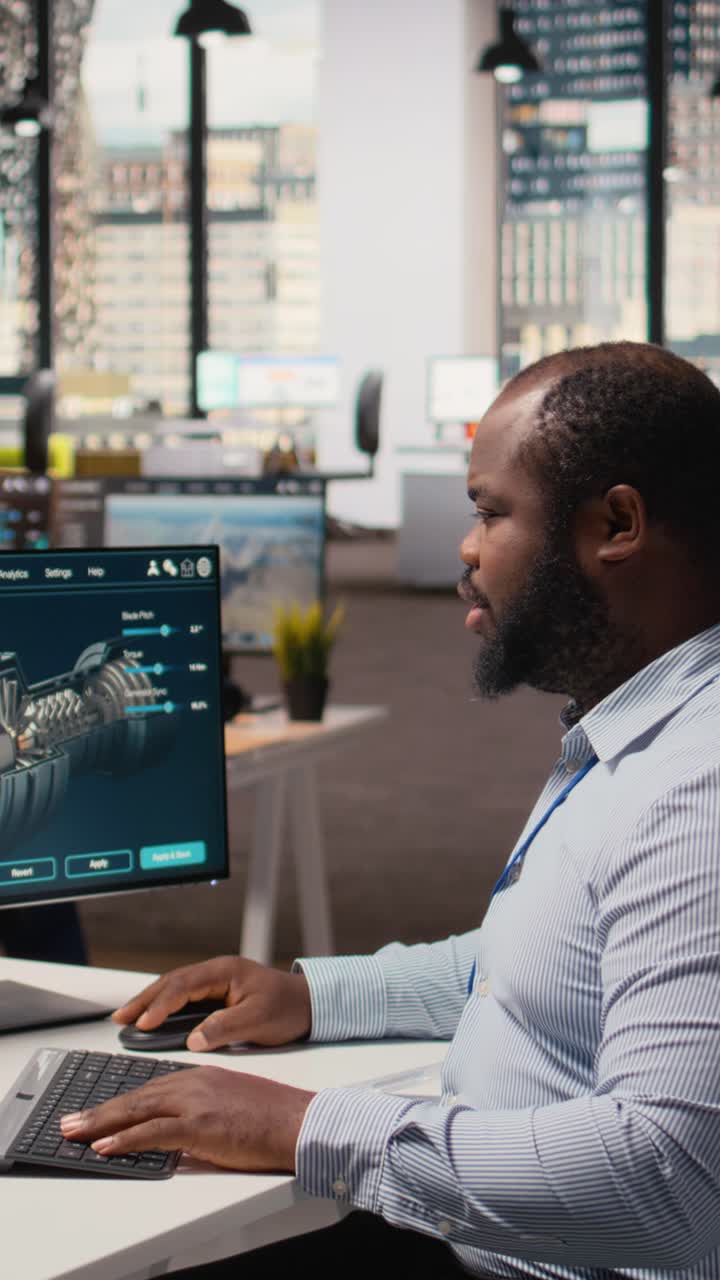 Technician using CAD software to optimize wind turbine blade aerodynamics