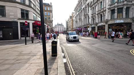 taxi navigating crowded london street scene