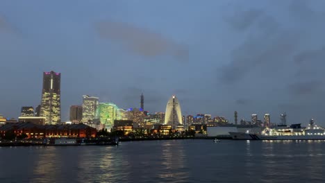 a stunning view of yokohama city skyline with lights reflecting on the water