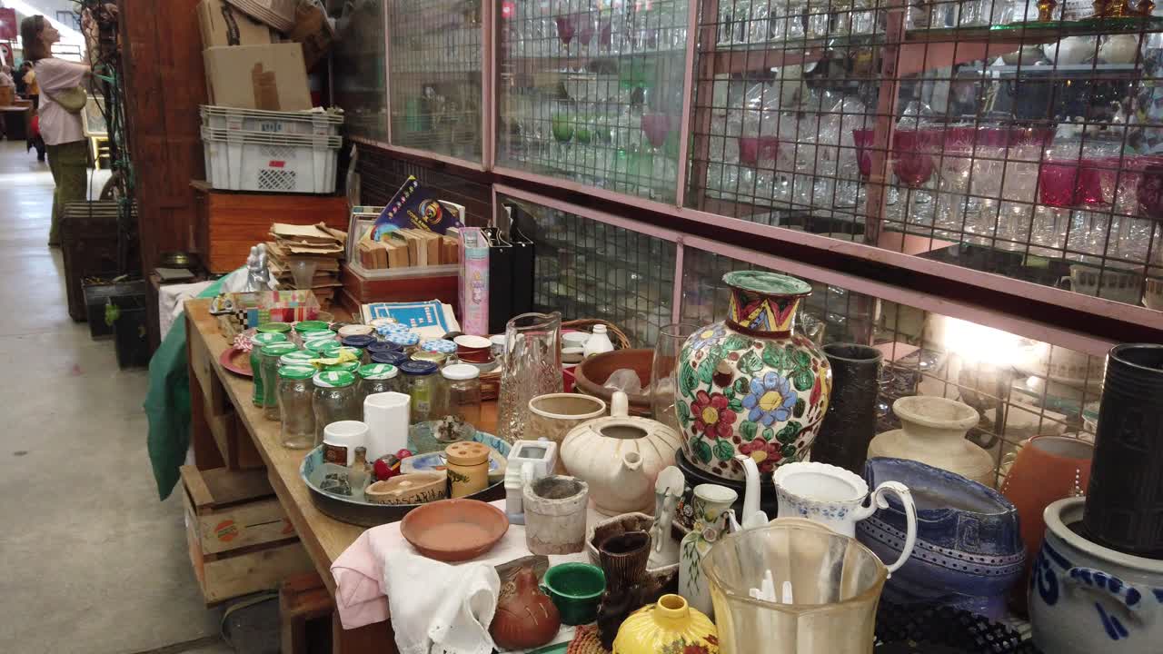 Panoramic people trade at vintage ceramic flea market shop in buenos aires city